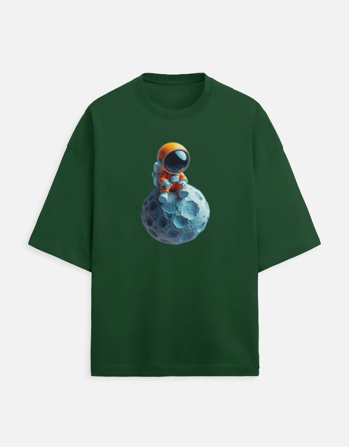 Green t-shirt with cartoon astronaut in orange suit sitting on a blue asteroid graphic