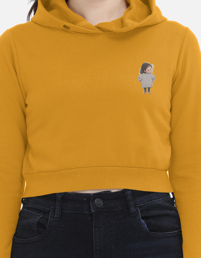 “Women’s Mustard yellow cropped hoodie with minimal left-chest cartoon graphic – stylish lightweight sweatshirt for casual wear.”