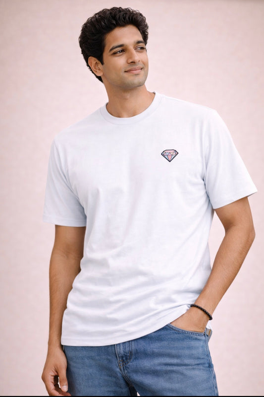 Man wearing a white t-shirt with a small logo on a light pink background