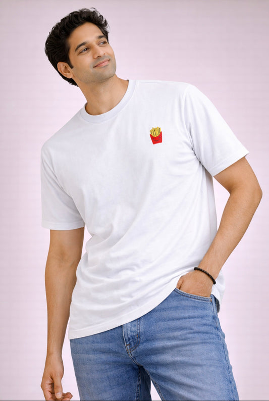 Man wearing a white t-shirt with a small graphic on a plain background