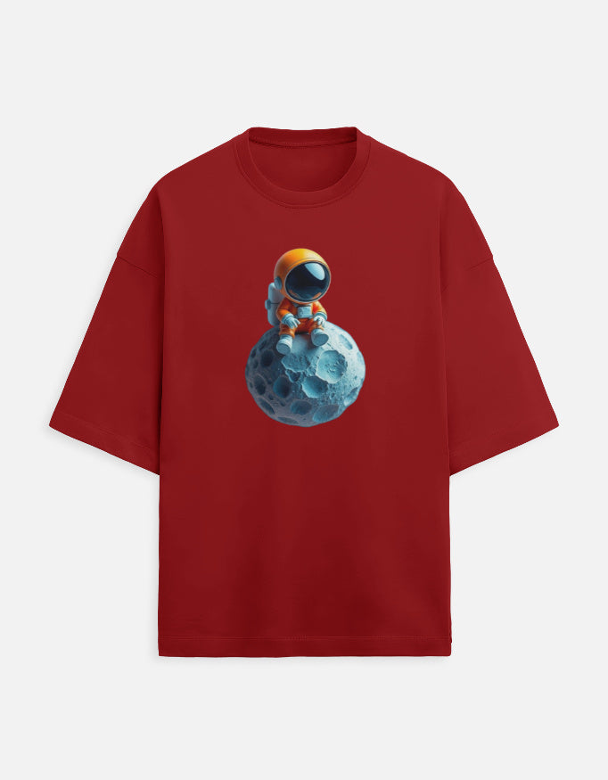 Red t-shirt with cute astronaut sitting on a blue asteroid graphic