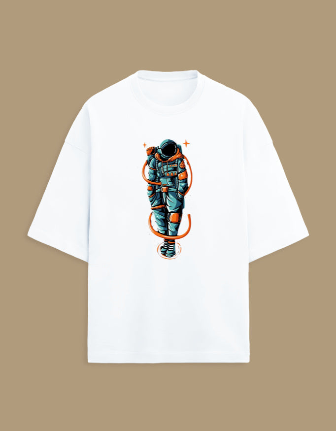 White t-shirt with colorful astronaut graphic design on front, beige background