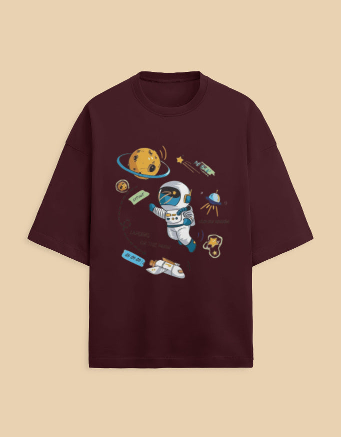 Burgundy t-shirt with cartoon astronaut, planets, and spaceship graphic, space theme