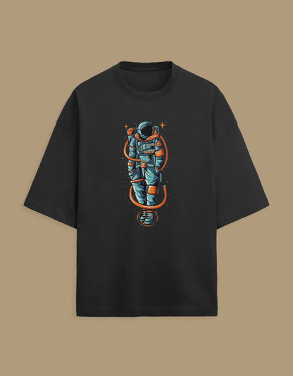 Black t-shirt with colorful astronaut graphic and orange space suit accents on front