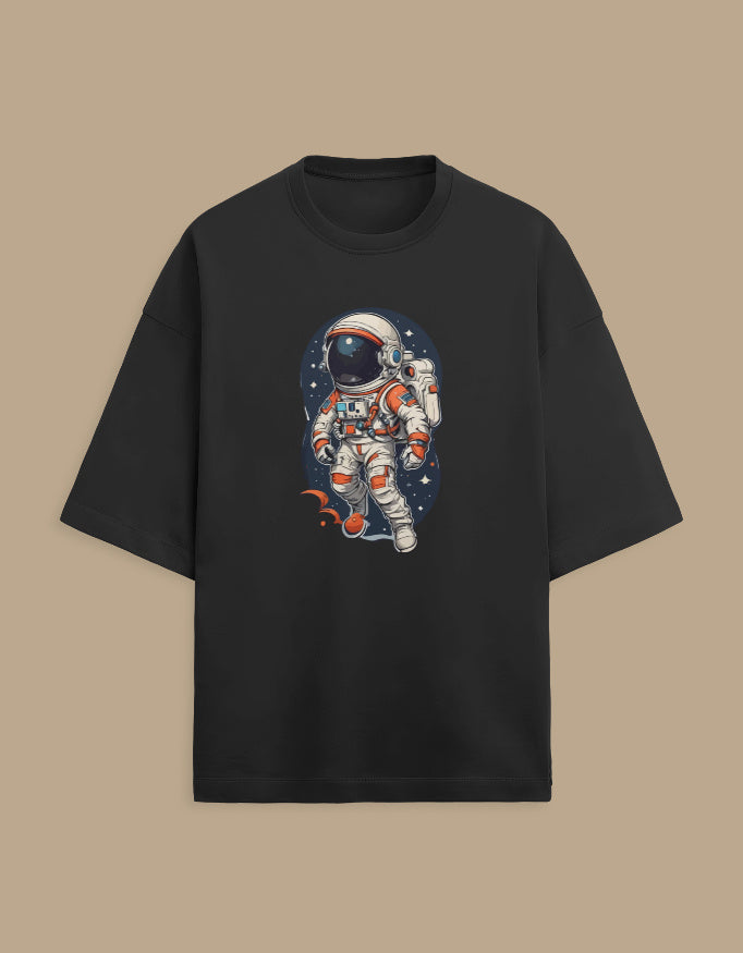 Black t-shirt with colorful astronaut graphic, space-themed design, on beige background