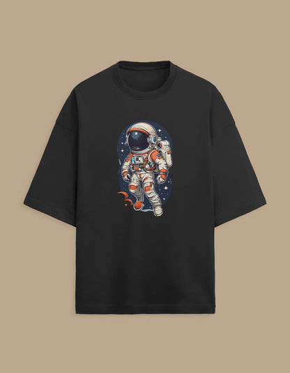 Black t-shirt with colorful astronaut graphic, space-themed design, on beige background