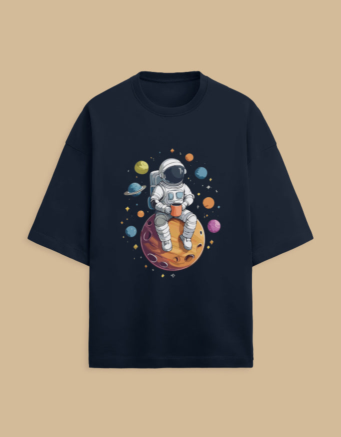 Black t-shirt with astronaut drinking coffee on planet with colorful space design