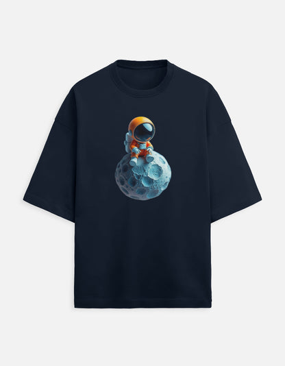 Navy t-shirt with cartoon astronaut in orange suit sitting on a blue asteroid graphic