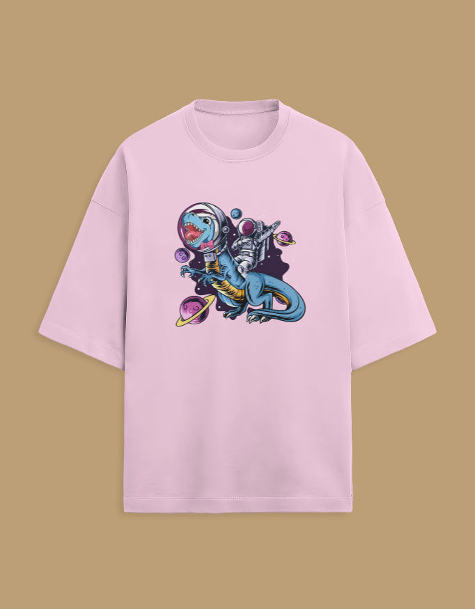Pink t-shirt with astronaut riding dinosaur and planets graphic on beige background