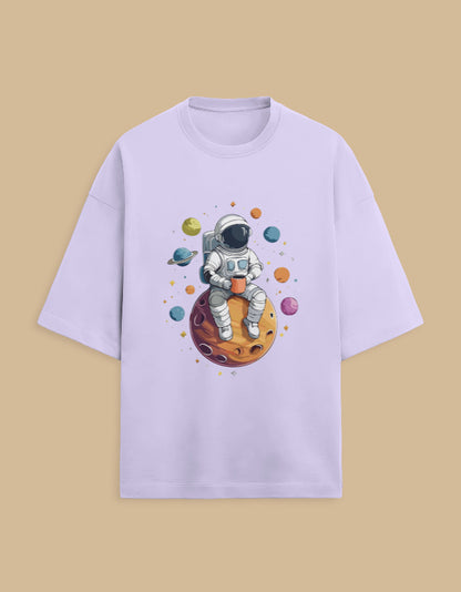 Lilac t-shirt with cartoon astronaut holding coffee, sitting on a planet with colorful space background