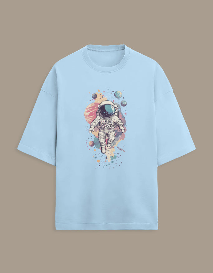 Light blue t-shirt with colorful astronaut and planets graphic, space themed shirt