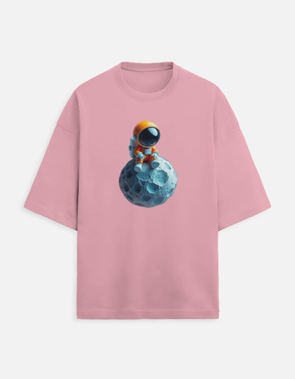 Pink t-shirt with cute astronaut sitting on blue moon graphic print, space-themed apparel