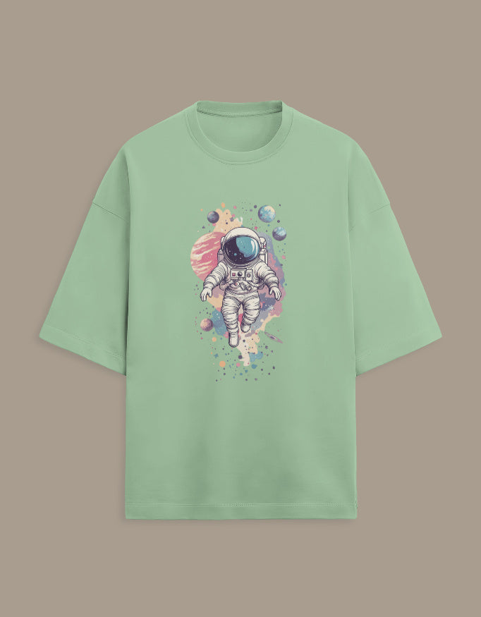 Mint green t-shirt with astronaut and colorful planets graphic print on front