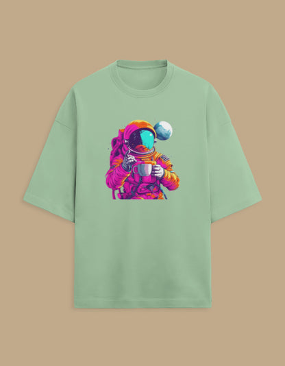 Mint green t-shirt with colorful astronaut drinking coffee graphic, planet in background