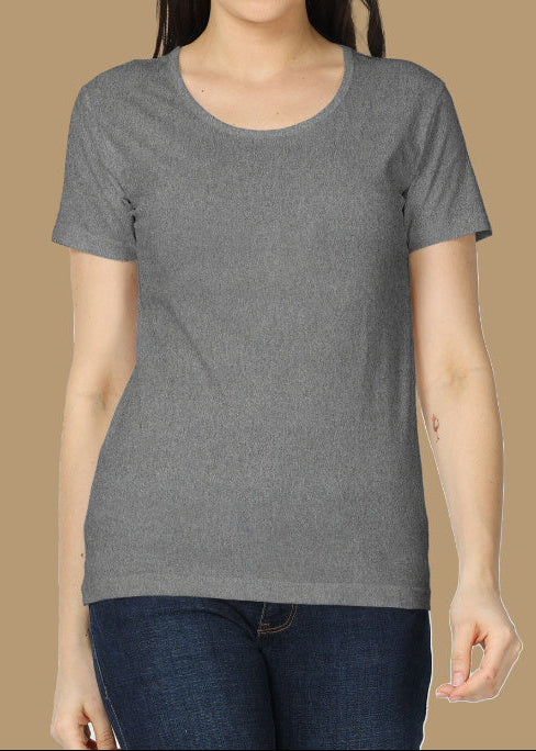 Woman wearing a gray t-shirt against a beige background