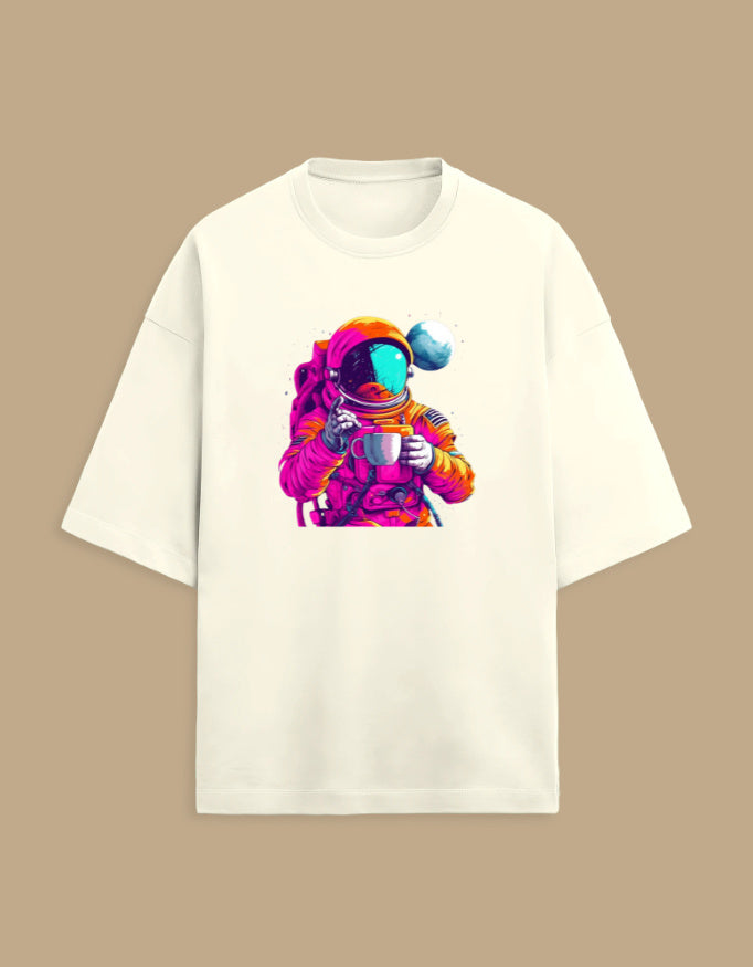 White t-shirt with colorful astronaut holding coffee cup graphic, tan background