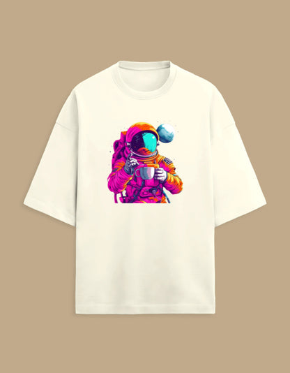 White t-shirt with colorful astronaut holding coffee cup graphic, tan background