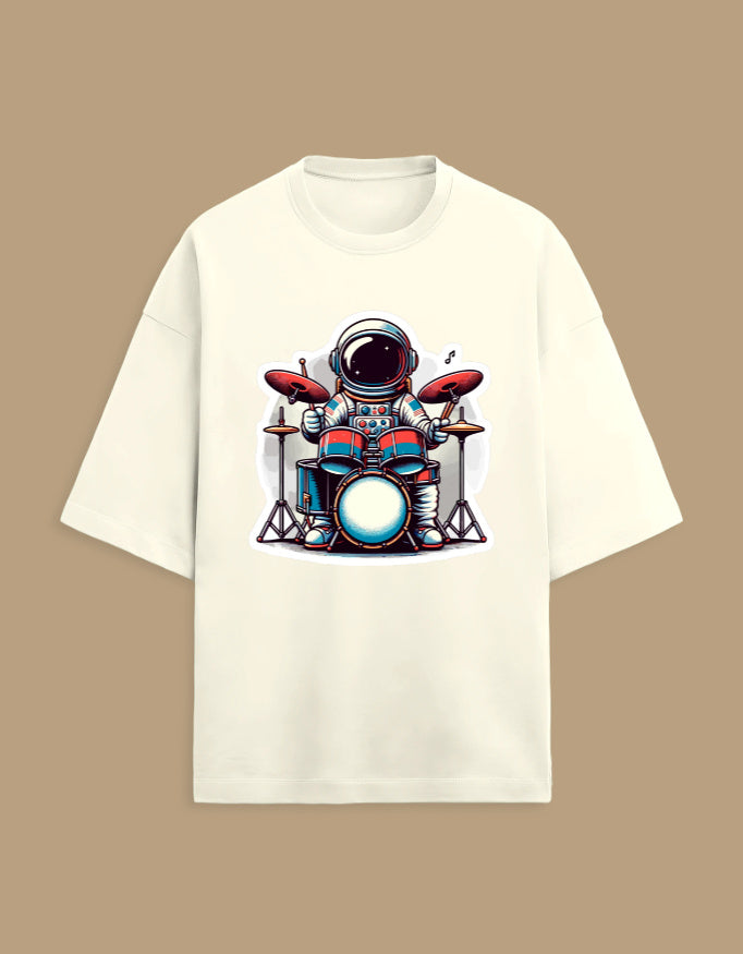Cream t-shirt with astronaut playing drums cartoon graphic, music novelty tee