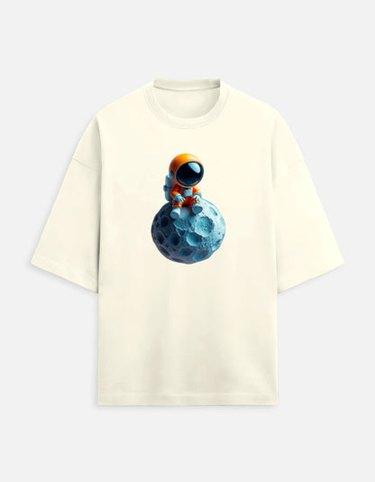 Beige t-shirt with cartoon astronaut sitting on a blue moon graphic