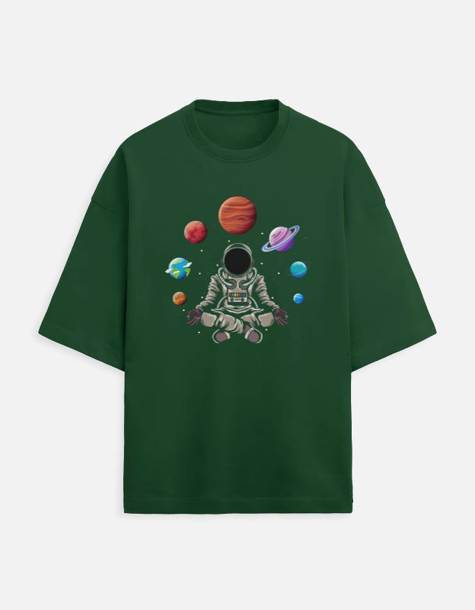 Green t-shirt with graphic of meditating astronaut and colorful planets in space