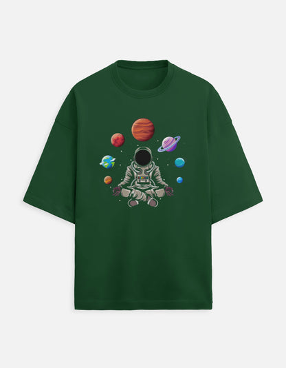 Green t-shirt with graphic of meditating astronaut and colorful planets in space
