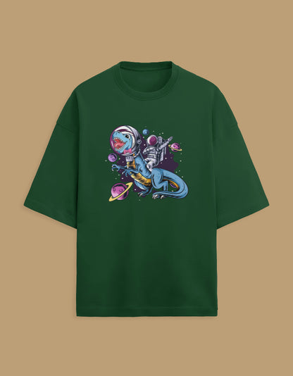 Green t-shirt with astronaut riding a dinosaur in space graphic and colorful planets