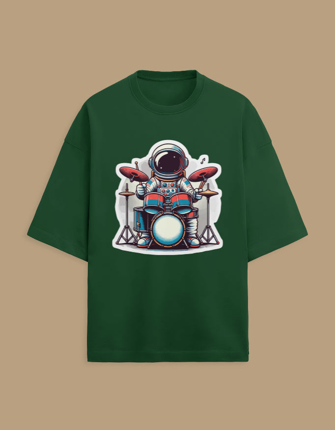Green t-shirt with astronaut playing drums cartoon graphic on front