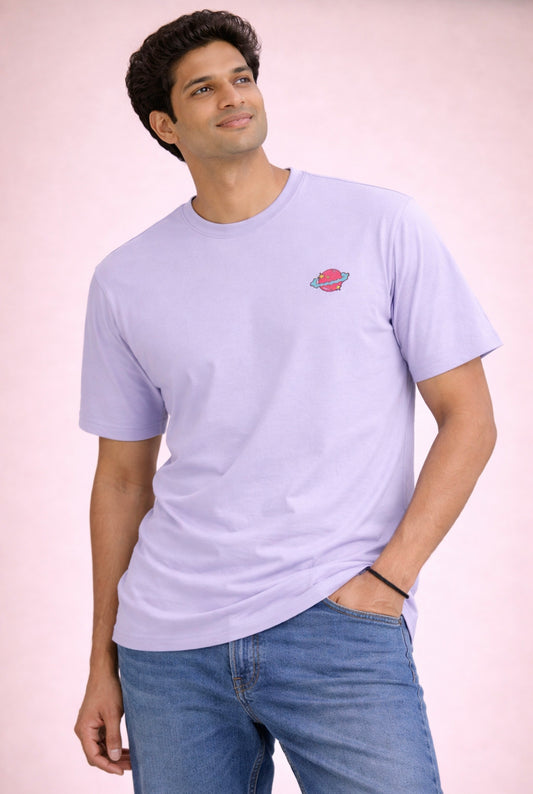 Man wearing a light purple t-shirt with a small logo on a plain background