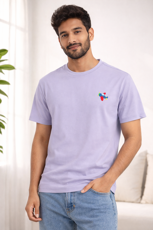 Man wearing a light purple t-shirt with a colorful embroidery 