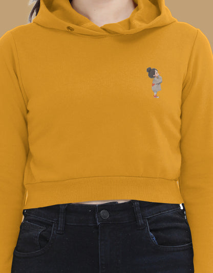 Women’s Mustard Yellow cropped hoodie with minimal left-chest cartoon graphic – stylish lightweight sweatshirt for casual wear.