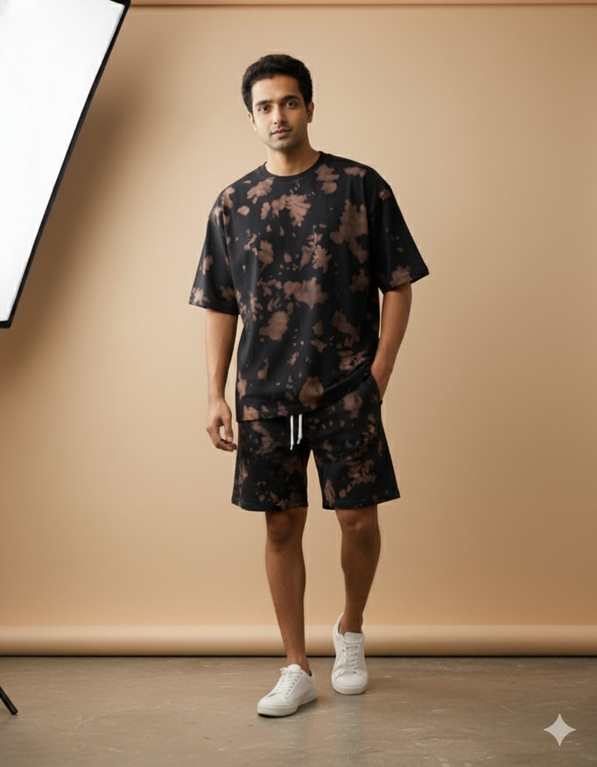 Man wearing black and brown tie-dye oversized co-ord set, standing in a minimalist studio — iTiDharma premium apparel.